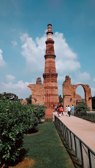 Desk with notebook, pen, and laptop showing charts